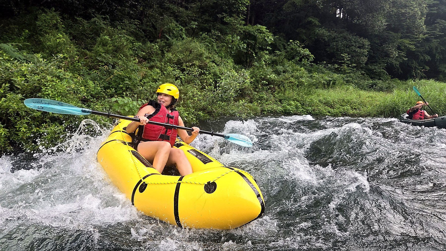 Tokyo Pack Raft on the Tama River with a guest paddling through whitewater near Tokyo