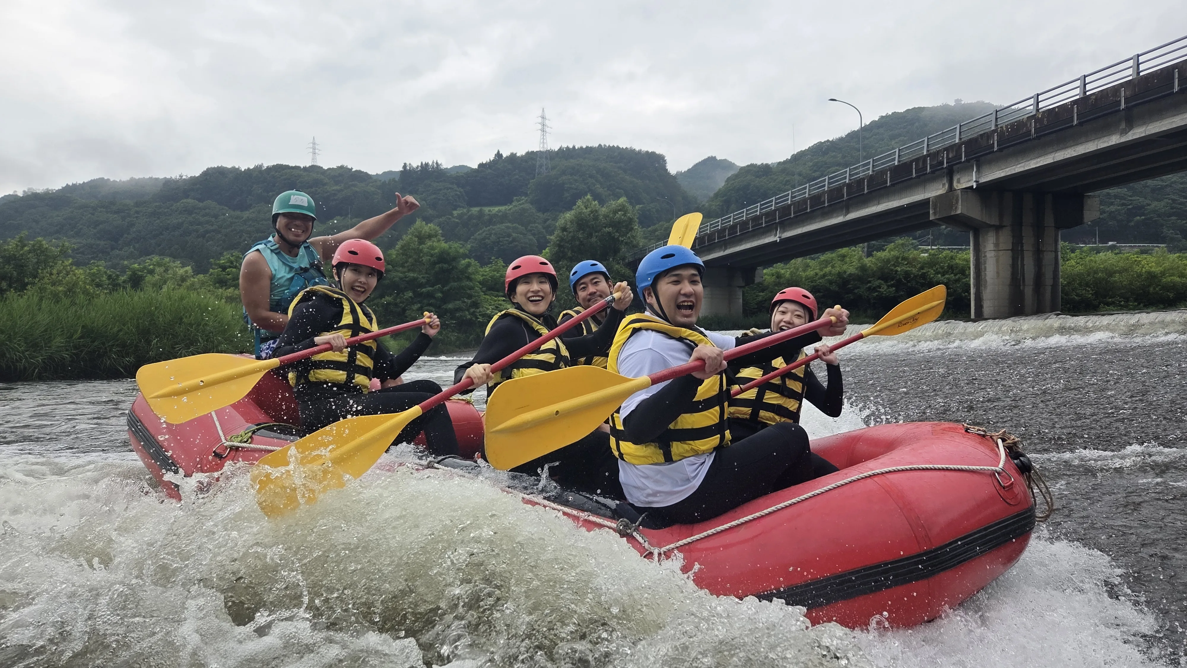 Experienced Feel Outdoor guide leading a happy group on a Tama River rafting tour near Tokyo