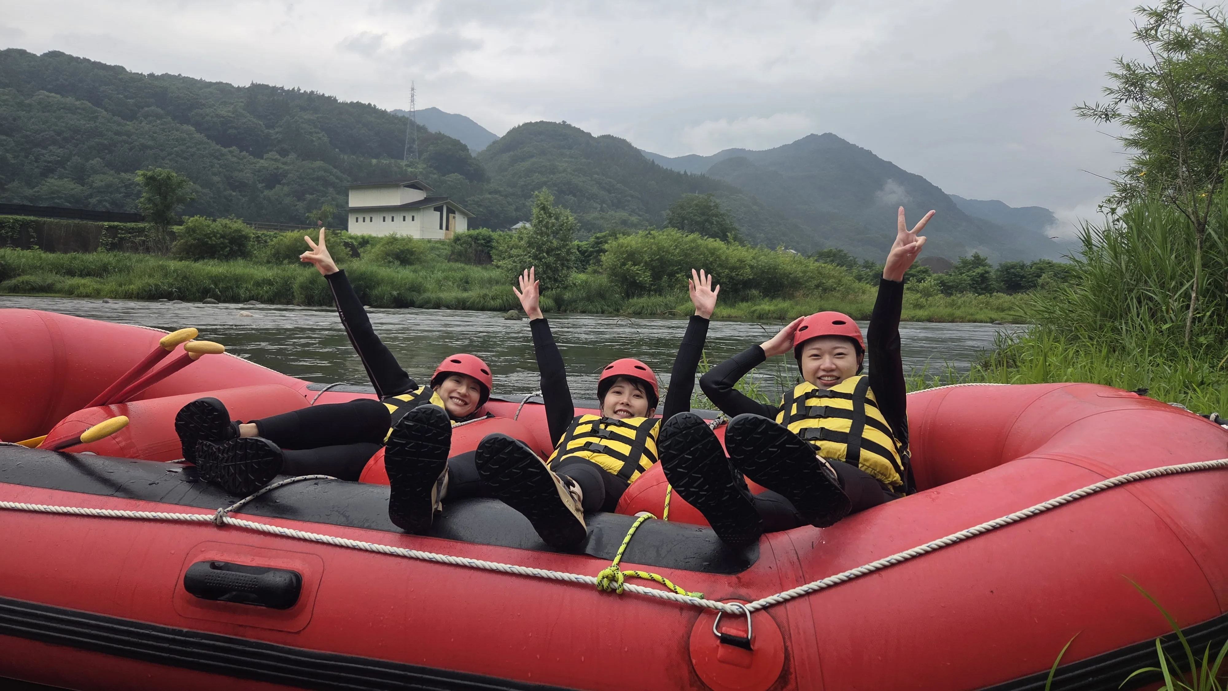 Visitors smiling after an English-friendly rafting adventure on the Tama River in Tokyo Japan